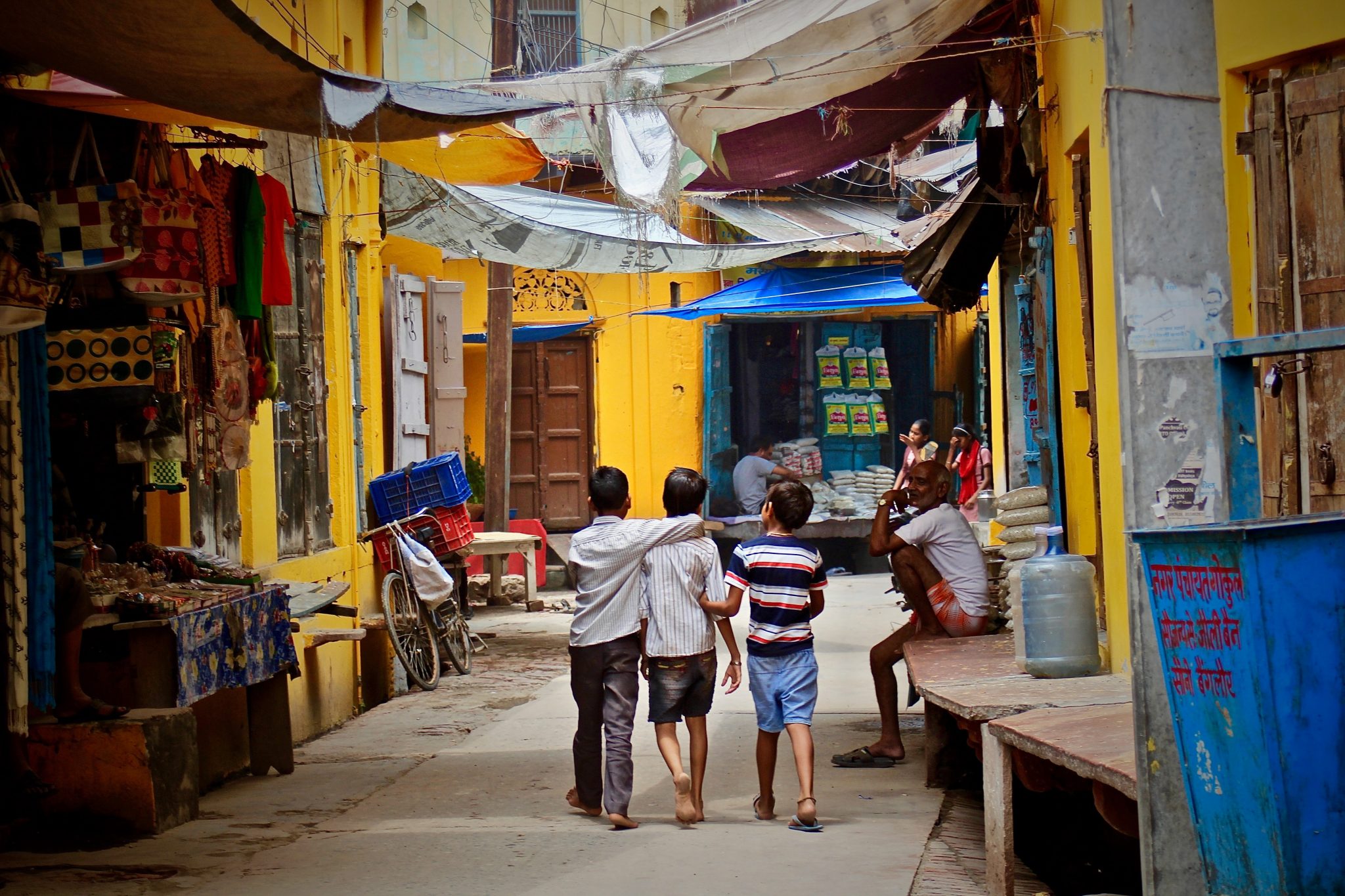 Three boys walking in the street