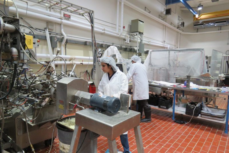 Bindvi Arora stands behind an extruder machine