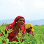 women smiling in field