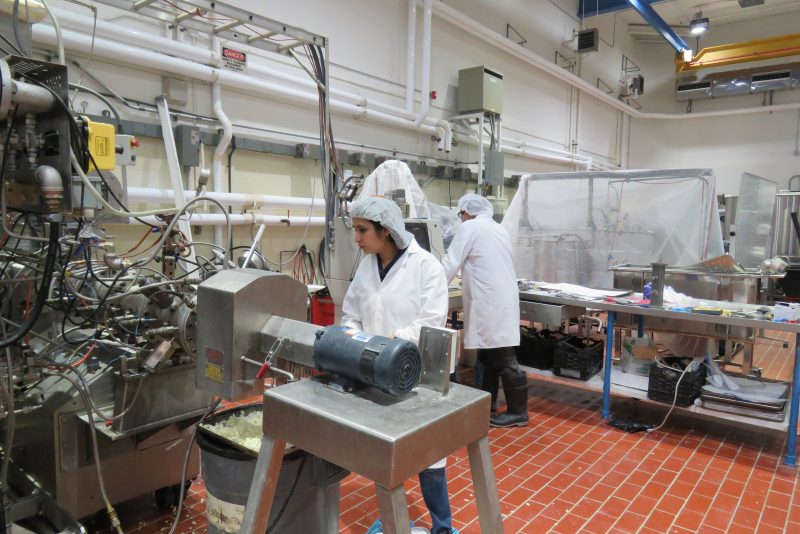 Bindvi Arora standing behind an extruder machine