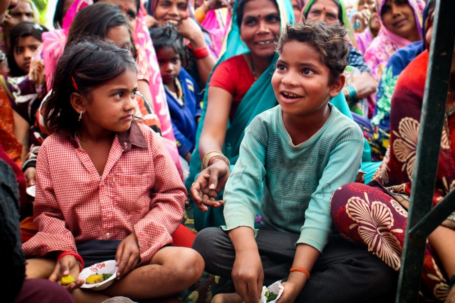 Children sitting and eating sweet potatoes