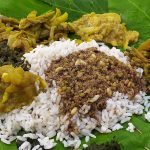 Cooked rice and vegetables on a leaf
