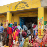 People purchasing grain from a shop