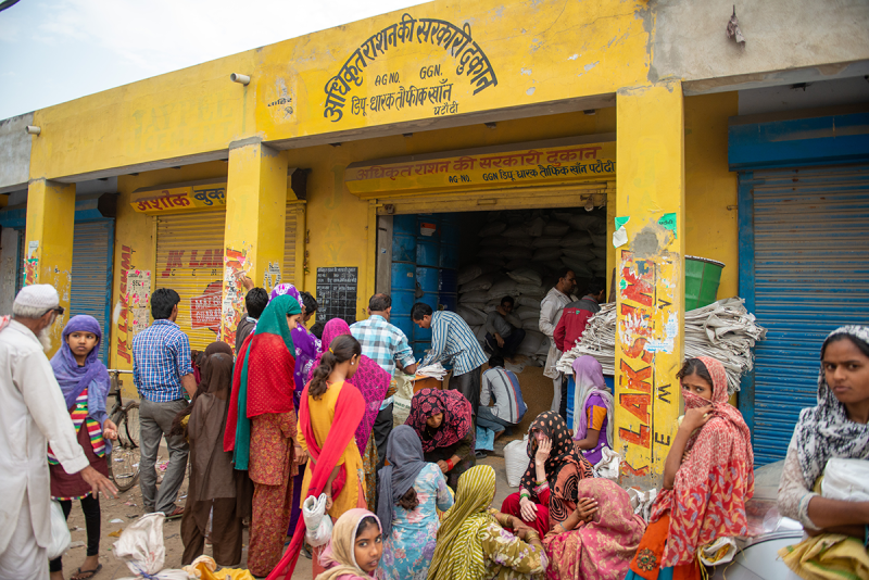 People purchasing grain from a shop