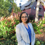 Anaka Aiyar in front of the Big Red Barn at Cornell University