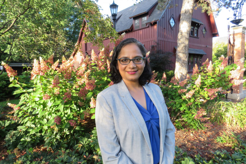 Anaka Aiyar in front of the Big Red Barn at Cornell University