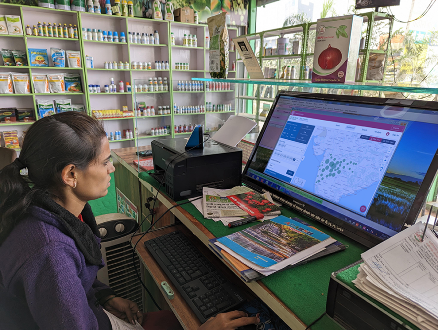 A farmer looks at the FPO database on her computer