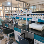 Two people standing by equipment in a lab