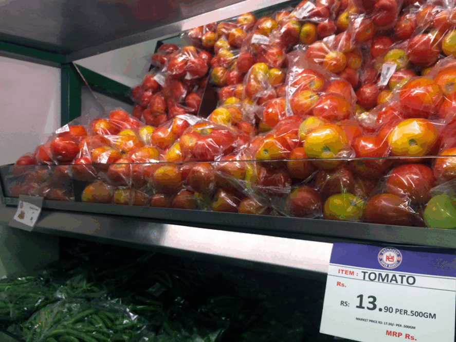 Tomatoes in plastic bags on a supermarket shelf